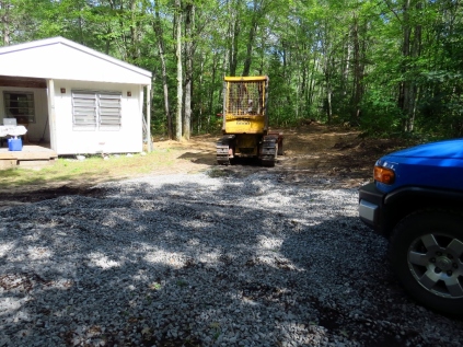 The bulldozer in our yard and extra gravel.